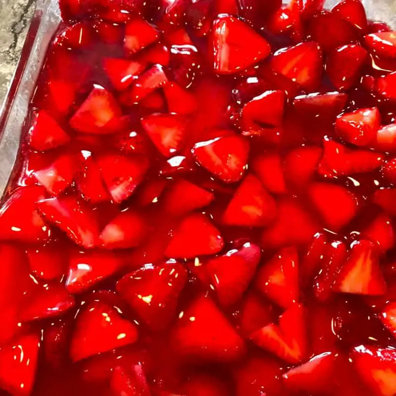 A close up of the strawberry topping layer for the cheesecake bars.