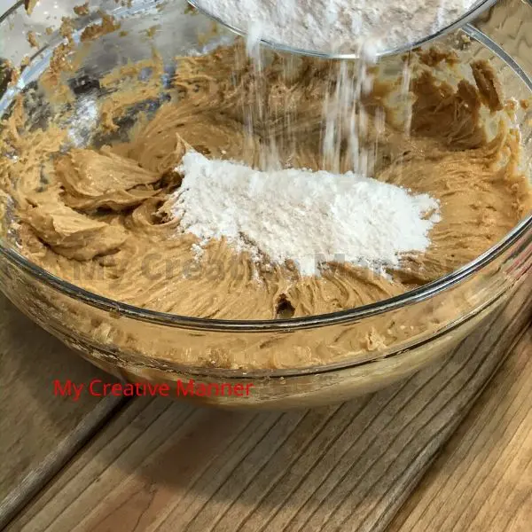 Flour being added to the cookies batter.