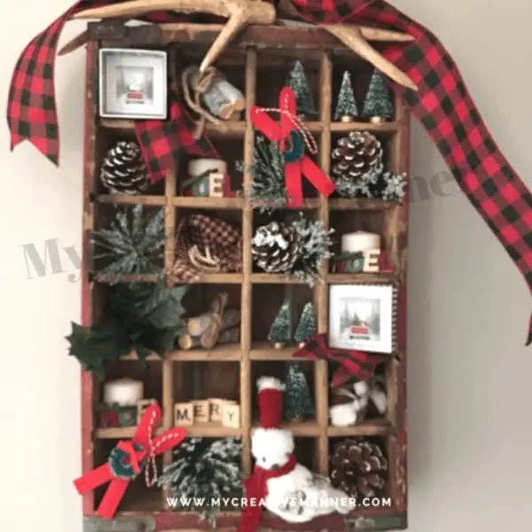 Antique Coke crate that is filled with many small Christmas decorations.