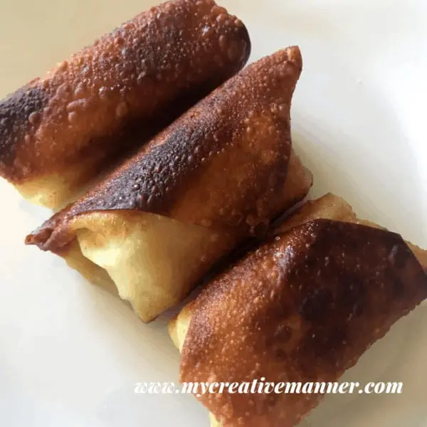three deep fried pickle wrapped egg rolls