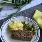 Blue placemat with a plate that has The Best Ever Meatloaf , mashed potatoes, and broccoli on it. There is a yellow napkin on the left of the plate while on the right is a fork.