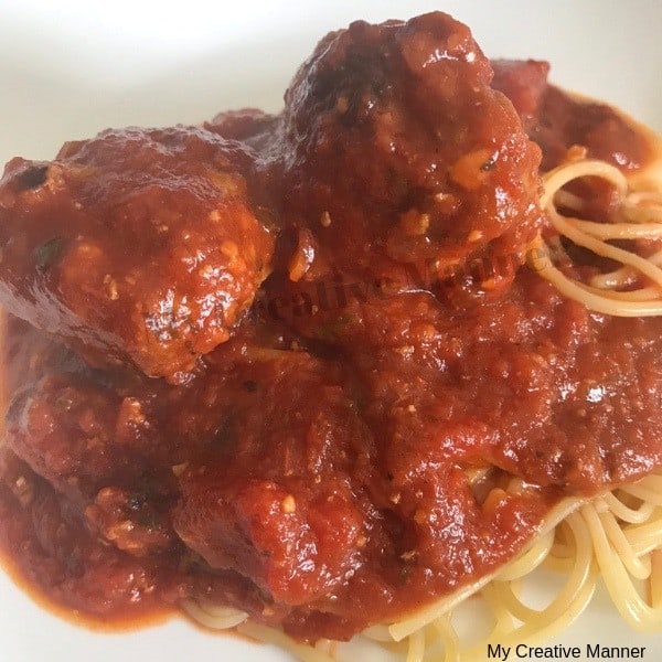 Marinara Sauce with Meatballs on a white plate.
