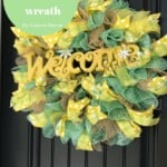 Green, yellow, and brown mesh wreath with a welcome sign on it.
