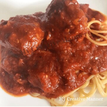 Marinara Sauce over spaghetti with two meatballs