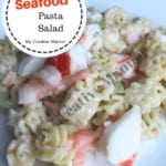 Seafood salad recipe with crabmeat and shrimp on a white plate.