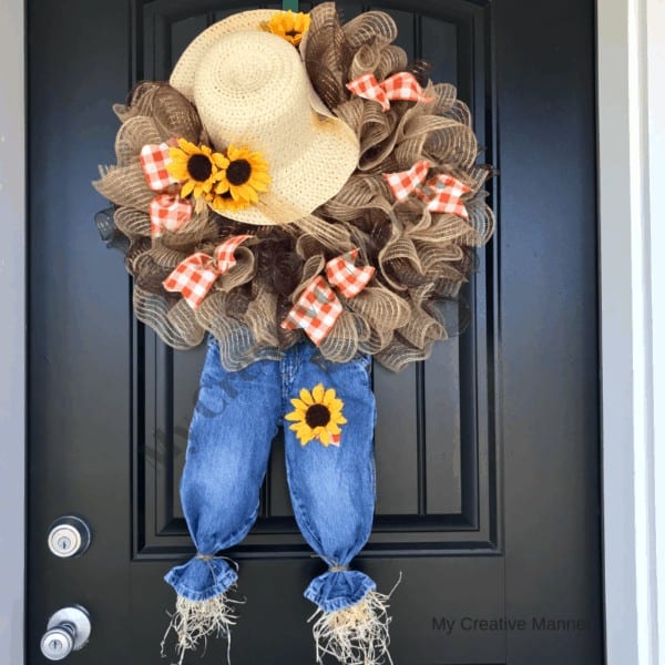 Scarecrow wreath on a black door.