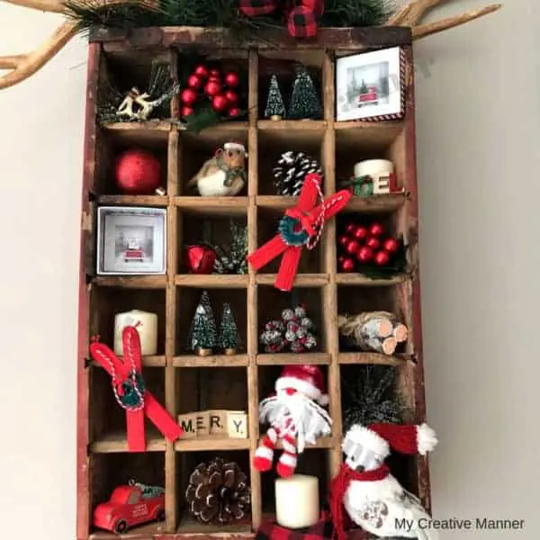 Wooden Coke crate that is filled with Christmas decorations.