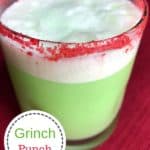 Grinch Punch in a glass that has red sugar sprinkle around the top of the glass. The words Grinch Punch are in a circle at the bottom left side of the picture.