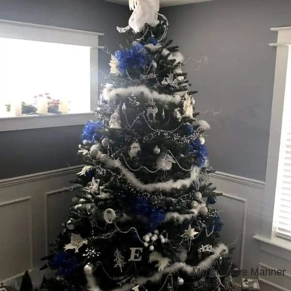 Christmas tree that has white and blue decorations.