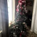 Rustic Christmas Tree with a large bow on top of the tree.