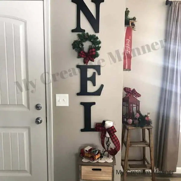 Wood Letters and mini wreath that spell out Noel.