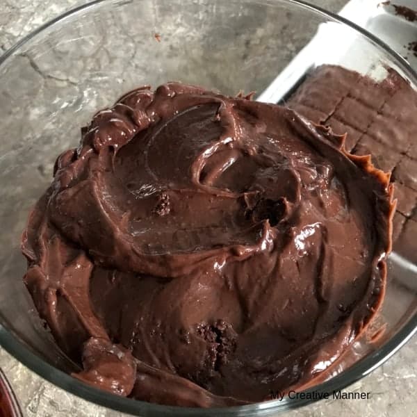 Layer of chocolate pudding in the glass trifle bowl.
