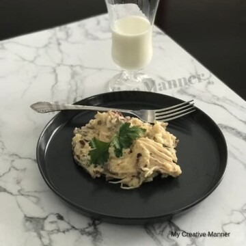 Pressure cooker chicken and rice on a plate with a fork.