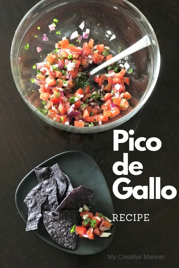 Clear Bowl with Pico De Gallo and a spoon in it. In front of the bow is a grey plate that has Pico De Gallo and Tortilla chips on it.