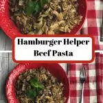 Red bowl filled with Hamburger Helper Beef Pasta with a red and white napkin next to the bowl with a fork on the napkin.