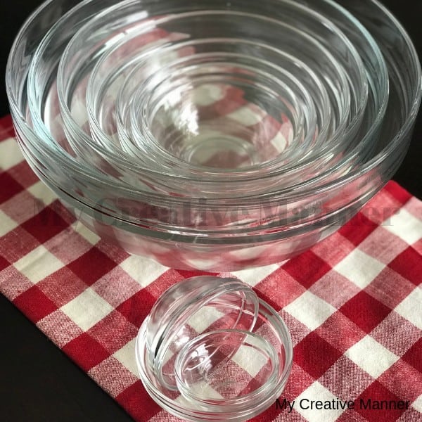 Glass nesting bowls sitting on a red and white napkin