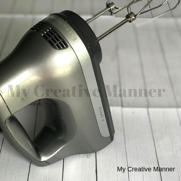 Picture of a grey hand mixer that has the beaters in it.