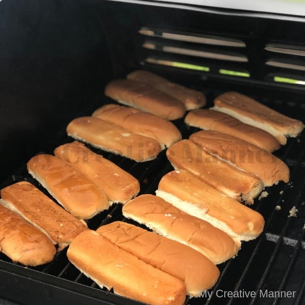Hot dog buns on a grill.