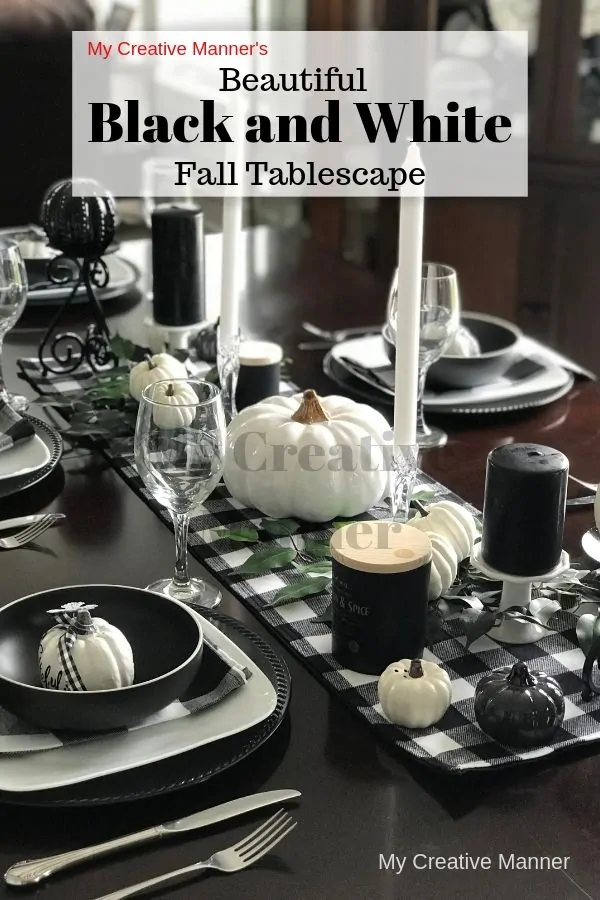 Black and white tablescape that has white pumpkins and a buffalo check table runner.