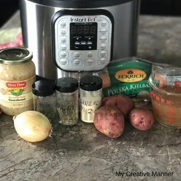 Instant Pot with ingredients for Kielbasa and sauerkraut recipe in front of it.