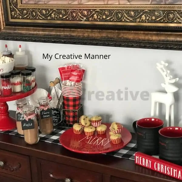 Side bar that is filled with Christmas decor and hot chocolate supplies.