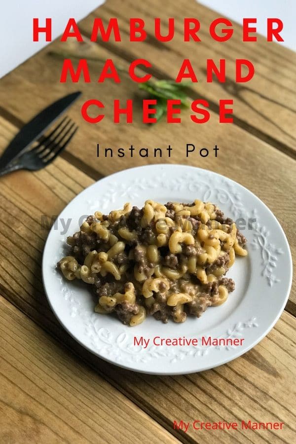 A white plate that has Cheeseburger macaroni on it with a fork and knife next to the plate. The words Hamburger Mac and Cheese Instant Pot are at the top of the image.