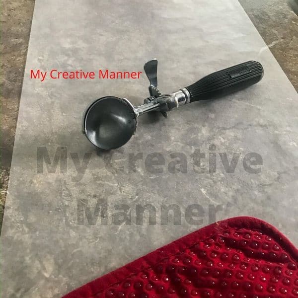 An ice cream scoop that is on wax paper.