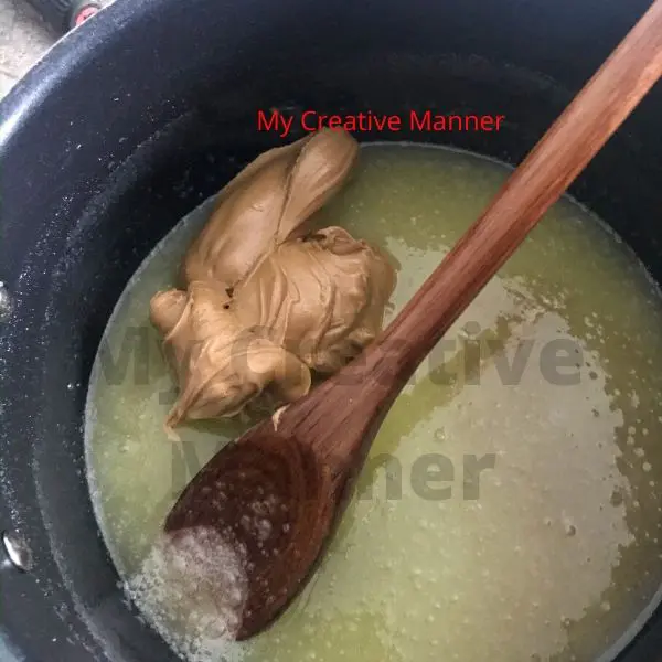 peanut butter being added into melted butter and sugar for peanut butter no bake cookies.