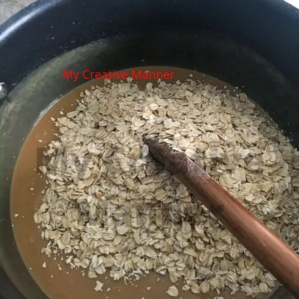 Oatmeal being added to the melted peanut butter, sugar, and butter mixture.