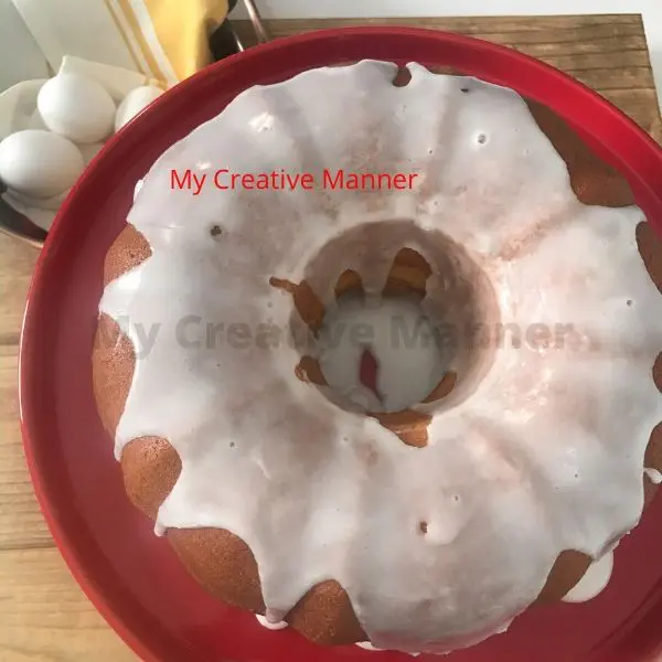 Lemon Bundt Cake on a red cake stand.