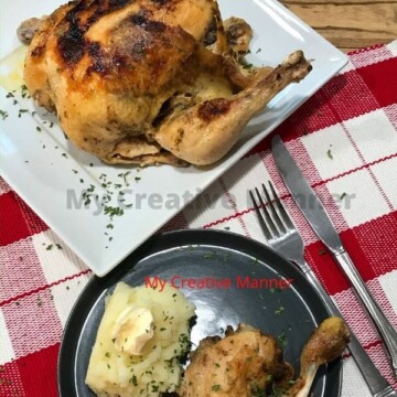 A chicken leg quarter on a plate with mashed potatoes. Behind the plates is another plate with the whole chicken on it that was cooked in a pressure cooker
