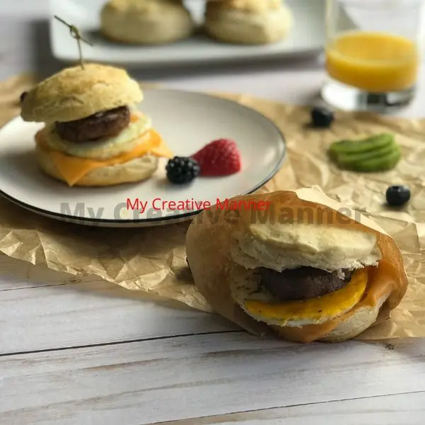The breakfast egg sandwich wrapped up and one on a plate.