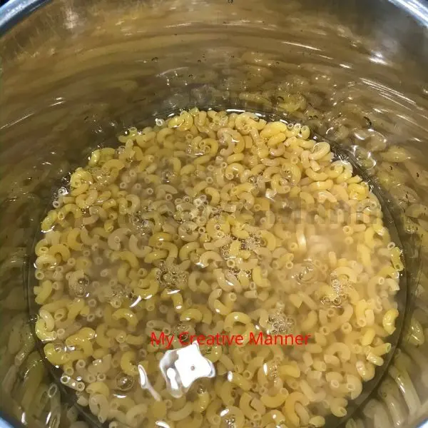 Elbow noodles in the inner pot of an Instant Pot.
