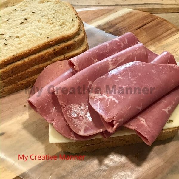 Corned beef on bread for a grilled sandwich.