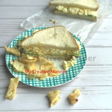 Egg Salad Sandwich on a plate with chips.
