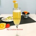 Orange juice and champagne drink in a flute glass.