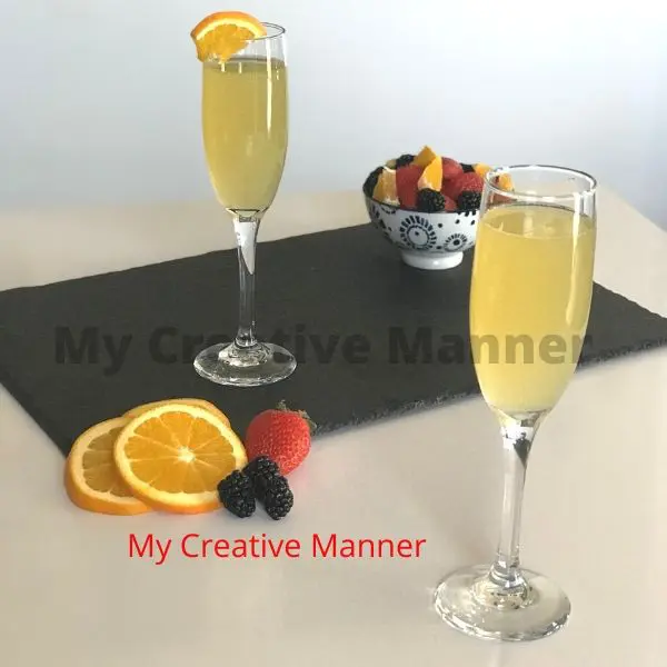 Champagne and orange juice in a flute glass.