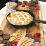 S'mores Dessert Board with cookies, candies, and fruit.