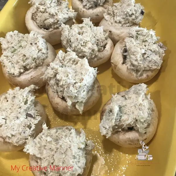 Unbaked stuffed mushrooms in a baking dish