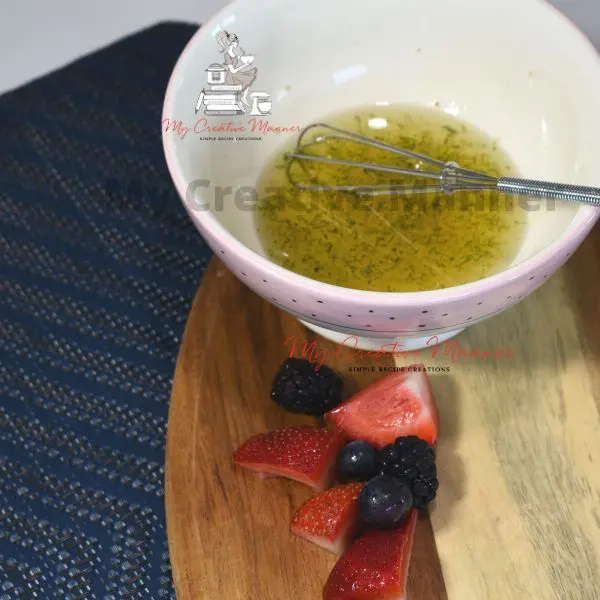 A small bowl with honey lime dressing in it.