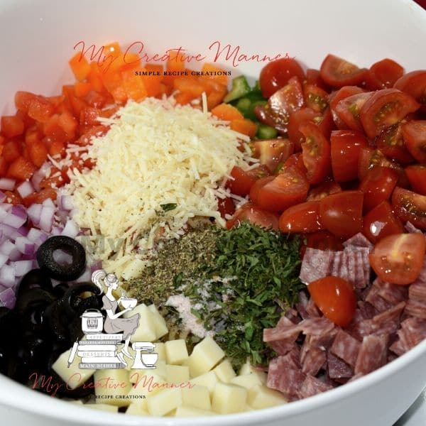 Large bowl filled with ingredients for a summer salad.