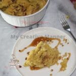 A baking dish that is filled with Instant Pot apple dump cake and more on a plate.