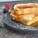 Toast that has syrup being pour on top of it.