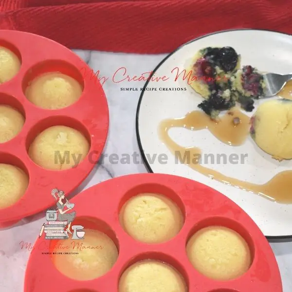 The molds filled with pancake bites and two on a plate with a fork.