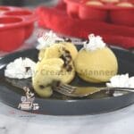 Chocolate chip pancake bites on a plate with cool whip.