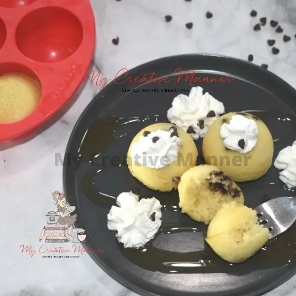 Three chocolate chip pancake bites on a plate with a fork.