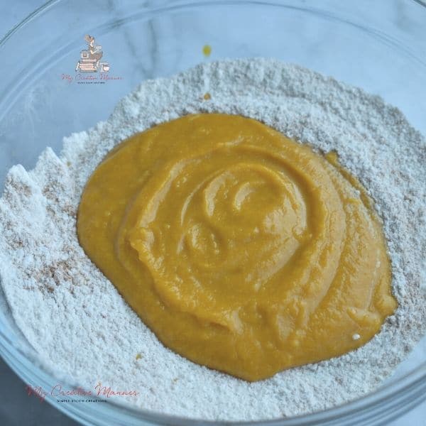 Pumpkin puree mixture in with flour.