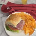Submarine Sandwich on a plate with chips.