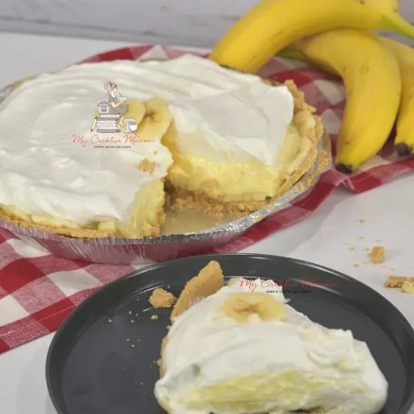 A whole pie with a slide missing from it. The slice is on a plate in front of the whole pie.