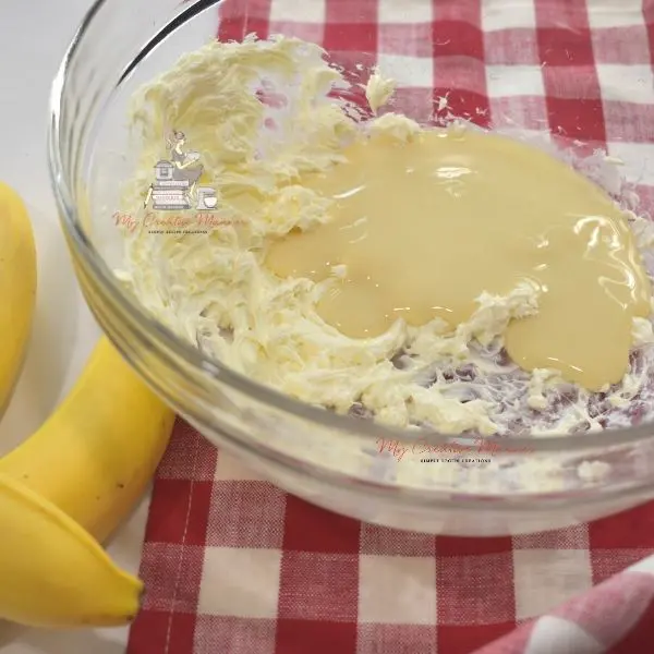 Instant pudding being mixed together with cream cheese.